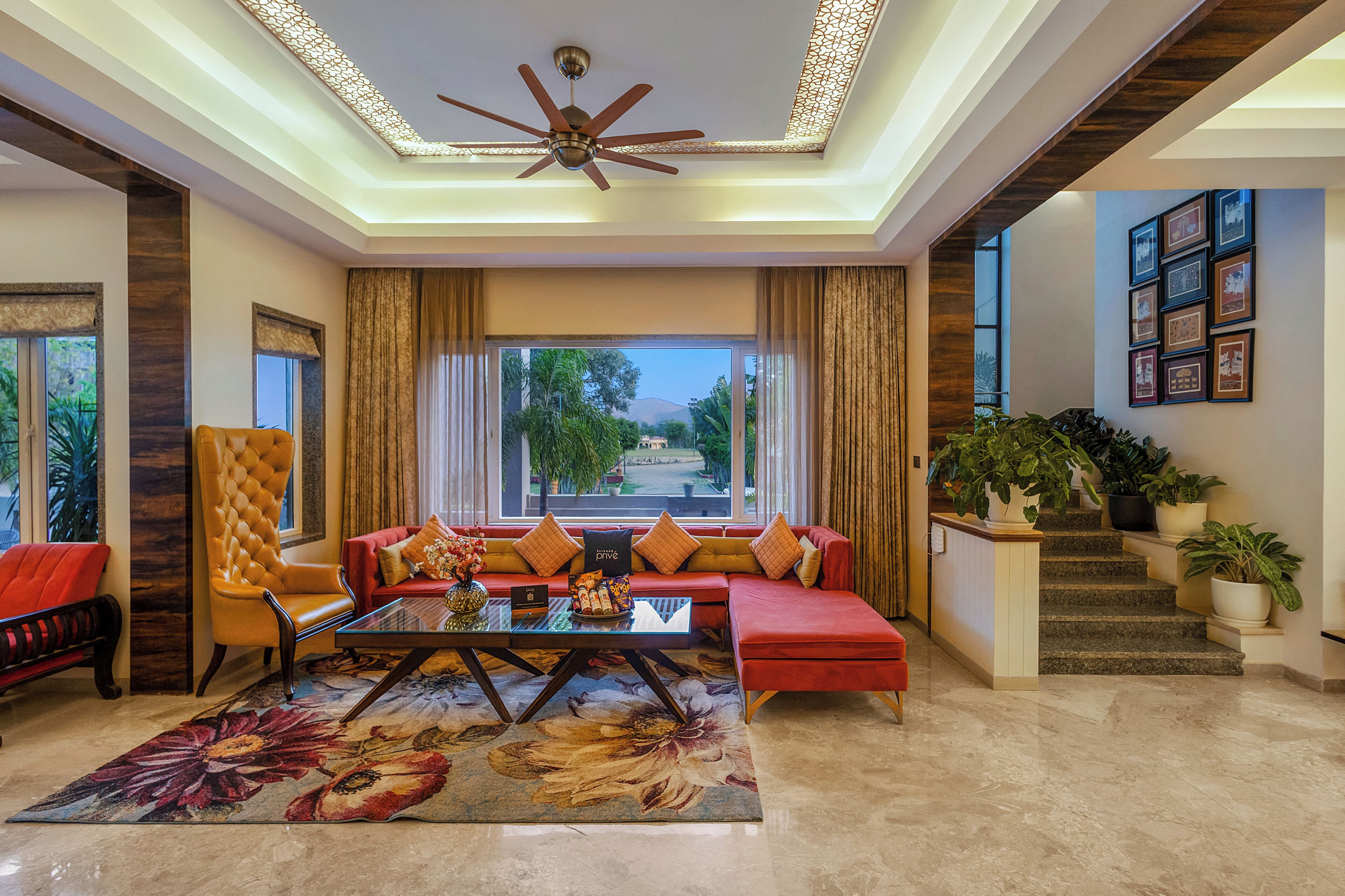 A spacious living area with a sofa, armchair, and a coffee table.