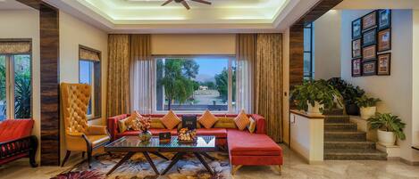 A spacious living area with a sofa, armchair, and a coffee table.