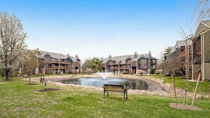 A residential building complex with a central water feature and a bench. - Eagles Landing - updated condo w/two balconies, WiFi, W/D, & AC - great location (Rehoboth Beach)