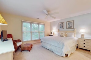 A bedroom with a bed, a desk, a chair, a window, and a ceiling fan. - Sea Colony condo with pool, hot tub, sauna, fitness room, gas fireplace & deck (Bethany Beach)