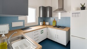 A modern kitchen with a sink, stove, and cabinets. - Santos (Lisbon)