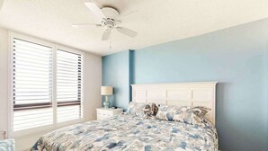 A bedroom with a bed, a nightstand, a lamp, and a ceiling fan. - 8th floor Sea Colony Oceancondo w/ balcony, elevator, and gym (Bethany Beach)