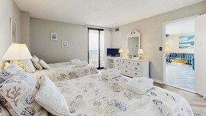 A hotel room with two beds, a dresser, a TV, and a balcony with a view. - Sea Colony Ocean 9th floor condo w/ elevator, tennis court, and pool (Bethany Beach)