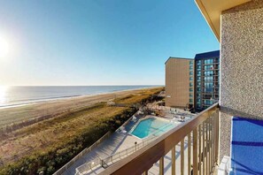 A hotel with a pool, a view of the beach, and a building with multiple floors. - Sea Colony Ocean 5th floor condo w/ balcony, shared sauna, and pool (Bethany Beach)