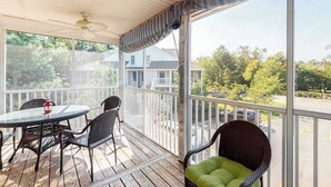 A covered outdoor area with a table and chairs, a ceiling fan, and a view of the neighborhood. - Sea Colony Tennis 2nd-floor condo with basketball court, pool, & tennis court (Bethany Beach)