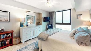 A bedroom with a bed, a dresser, a television, and a large window. - Sea Colony Ocean 3rd-floor condo with elevator & gym (Bethany Beach)