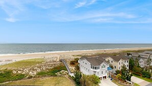 A coastal residential area with houses, a beach, and a clear sky. - Sea Colony Ocean 7th floor condo w/ basketball court, pool, and elevator (Bethany Beach)