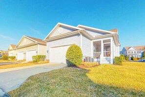 A suburban single-family home with a front porch, garage, and well-maintained lawn. - Bayside Resort townhouse w/ free WiFi, tennis court, pool, and board games (Selbyville)