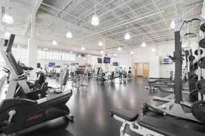 A gym with cardio machines, weightlifting equipment, and a large mirror. - Sea Colony Ocean 6th-floor condo with sauna, tennis court, & elevator (Bethany Beach)