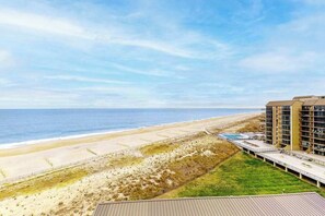 A beachfront hotel with a view of the ocean, a boardwalk, and a pool. - Sea Colony 9th floor condo with tennis court, elevator, gym & ocean view (Bethany Beach)
