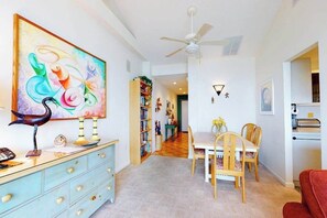 A dining area with a table, chairs, a ceiling fan, and a bookshelf. - Sea Colony 9th floor condo with tennis court, elevator, gym & ocean view (Bethany Beach)