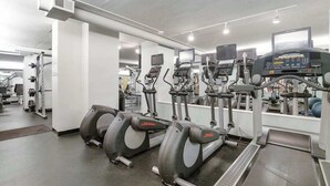 A gym with treadmills, elliptical machines, and weight machines. - Sea Colony Tennis 2nd-floor condo with fireplace, basketball court & sauna (Bethany Beach)
