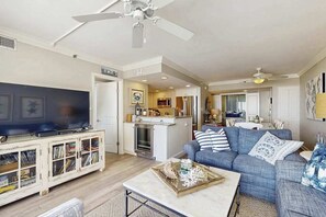 A living room with a television, sofa, and coffee table. - Sea Colony Ocean 4th floor condo w/ free WiFi, balcony, and basketball court (Bethany Beach)