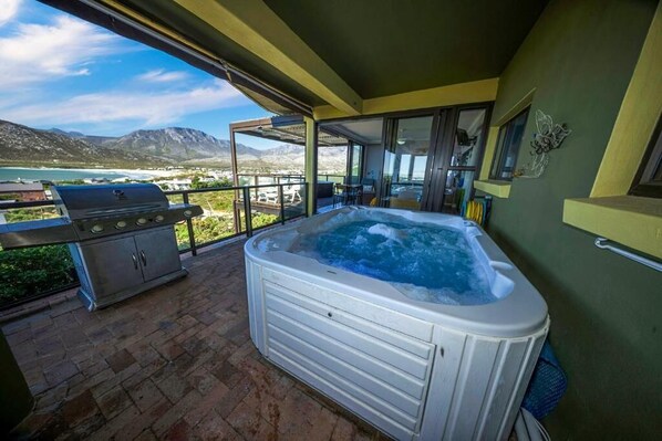 A hot tub on a balcony with a mountain view.