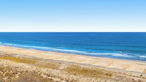 A beach with a clear sky and a sandy shoreline. - Sea Colony Ocean 8th floor condo w/ pool, free WiFi, & basketball court (Bethany Beach)