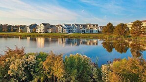 A row of houses by a lake with a clear reflection. - Updated Bayside Resort Home w/ Shared Pools, Easy Beach Access, & Fast WiFi (Selbyville)