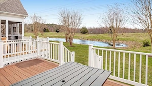 A wooden deck with a view of a river and trees. - Bear Trap Dunes townhome with central AC & washer/dryer - on-site pools & tennis (Ocean View)