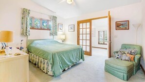 A bedroom with a bed, a chair, a desk, a lamp, and a ceiling fan. - Fenwick Island spacious beach house with deck, W/D & full kitchen - dog-friendly (Fenwick Island)