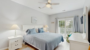 A bedroom with a bed, nightstands, a ceiling fan, and a window with curtains. - Bayside at Bethany Lakes townhome w/central AC, pool, hot tub & gym access (Ocean View)