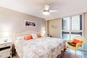 A bedroom with a bed, nightstands, a chair, a ceiling fan, and a window with blinds. - Sea Colony 3rd floor condo w/ elevator, shared tennis court & gym - ocean view (Bethany Beach)