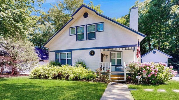 A single-story house with a front porch, a small attached garage, and a well-maintained lawn. - Savannahs Landing home w/ gas grill & shared pool, tennis, & playground (Ocean View)