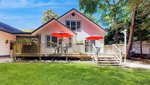 A two-story house with a porch, outdoor seating, and a small staircase leading to the entrance. - Savannahs Landing home w/ gas grill & shared pool, tennis, & playground (Ocean View)