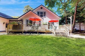 A two-story house with a porch, outdoor seating, and a small staircase leading to the entrance. - Savannahs Landing home w/ gas grill & shared pool, tennis, & playground (Ocean View)