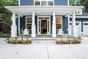 A two-story house with a porch, white columns, and a front door. - Bethany West Retreat W/ Shared Pool, Free WiFi, Full Kitchen & Ideal Location (Bethany Beach)