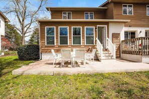 A two-story house with a front porch, a staircase, and a small garden area. - Bayberry Woods condo W/ shared pool, high-speed WiFi & central AC - near beach (Bethany Beach)
