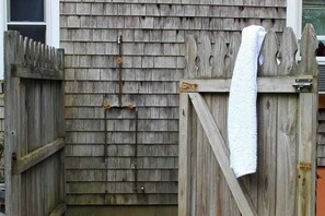 A wooden gate with a towel hanging on it.
