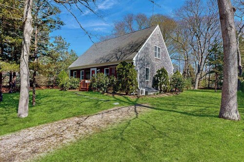 2-story home near the beach with large lawn, deck, W/D, streaming, & partial AC
