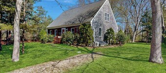 2-story home near the beach with large lawn, deck, W/D, streaming, & partial AC