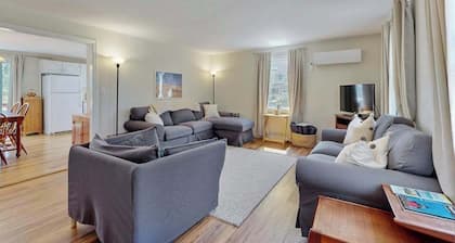 2-story home near the beach with large lawn, deck, W/D, streaming, & partial AC