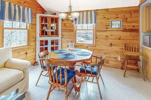 A wooden interior with a round table, chairs, a sofa, and a cabinet. - Dog-Friendly Home w/Yard, Deck, Free WiFi, New Gas Grill - Walk to the Beach (Chatham)