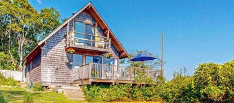 Water-view home with large deck, balcony, enclosed sunroom & peaceful location