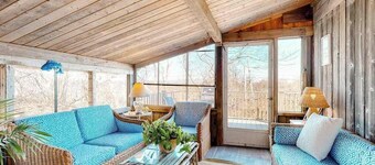 Water-view home with large deck, balcony, enclosed sunroom & peaceful location
