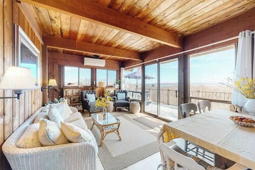 Water-view home with large deck, balcony, enclosed sunroom & peaceful location