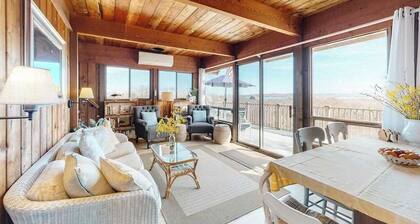 Water-view home with large deck, balcony, enclosed sunroom & peaceful location