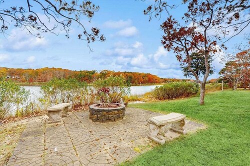 Waterfront Cape house with large deck, fireplace, modern kitchen & grassy yard