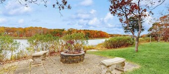 Waterfront Cape house with large deck, fireplace, modern kitchen & grassy yard