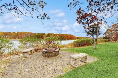 Waterfront Cape house with large deck, fireplace, modern kitchen & grassy yard