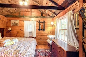 A wooden cabin bedroom with a bed, dresser, and window. - Charming, Dog-Friendly Cottage w/ Free WiFi & a Kitchenette - Close to the Beach (Eastham)