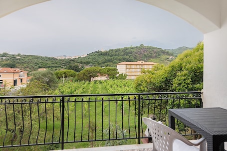 A balcony with a view of a green landscape and buildings.. Apartment '601' with Private Terrace and Shared Garden