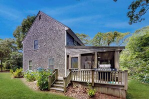 A two-story wooden house with a deck and a small porch. - Oak Bluffs Home with Renovated Screened-in Porch - Short Drive to Beach (Oak Bluffs)