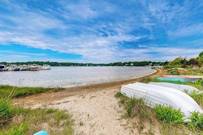 A beach with boats, a sandy shore, and a bridge in the background. - Neighborhood charmer with deck, W/D, Outdoor shower, Dog friendly, Wifi (Falmouth)