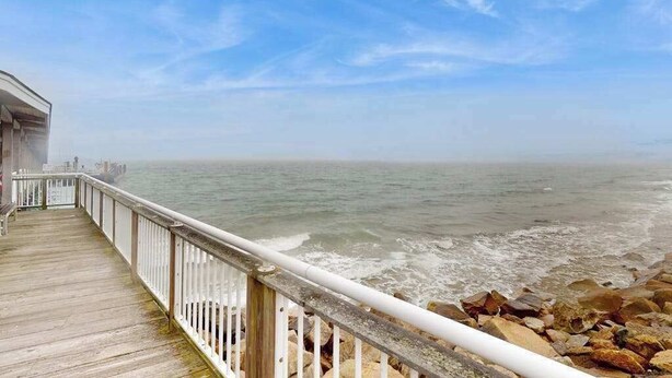 A wooden pier leading to a rocky shoreline with a clear sky. - Spacious colonial home close to town with AC, porches, & W/D (Oak Bluffs)