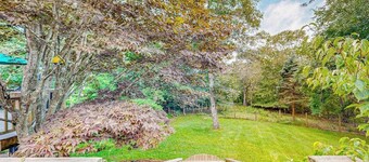 Charming 2-story house near the beach with inviting deck, large yard & canoe