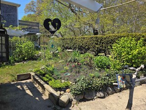 Property grounds - Historic cottage with patio, games, walk to beach & dog-friendly fenced yard (Oak Bluffs)