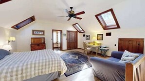 A bedroom with a bed, a chair, a desk, and a ceiling fan. - Gorgeous home near the ocean w/ a full kitchen, deck, & large, fenced back yard (Vineyard Haven)