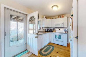 Fridge, microwave, oven, stovetop - Dog-friendly bay view cottage with a furnished porch, washer/dryer, & roof deck (Sandwich)